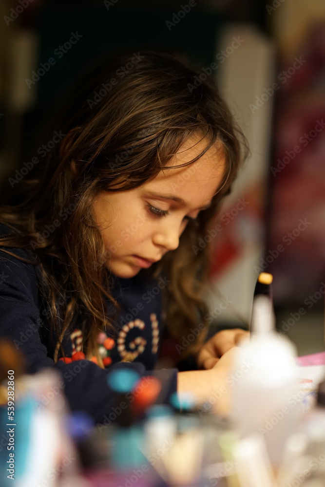 Young girl 6-7 years old drawing