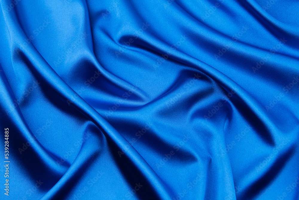 Obraz premium Blue satin or silk fabric as background