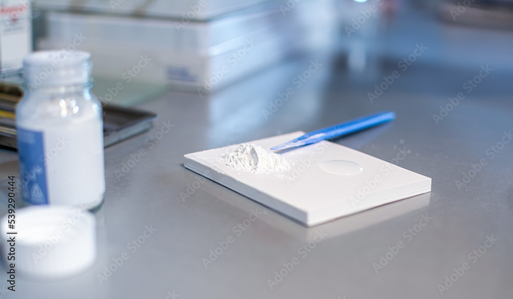 Close up of dental spatula and cement for fillings on desk in dental office.