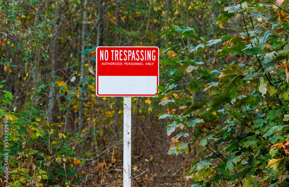 No trespassing warning sign along road