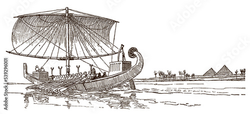 Ancient Egyptian boat navigating on River Nile in front of Pyramids