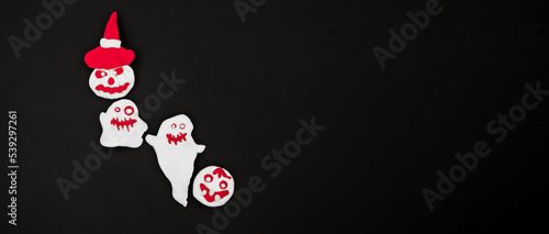 halloween red and white ghosts  scary pumpkins from air plasticine on black background