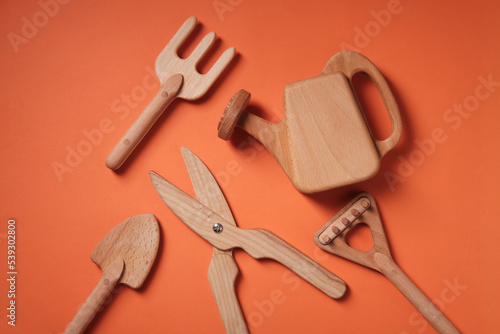 Children's wooden toys, garden accessories, on an orange background