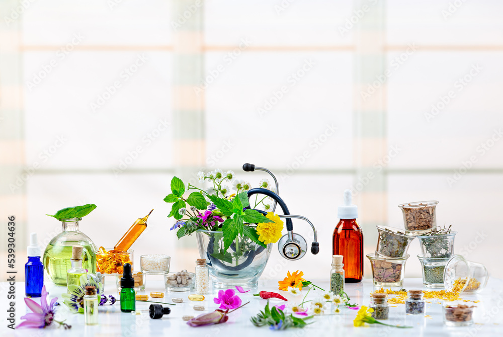 Natural healthcare concept-Herbal plant medicine preparation with herbs and flowers, mortar with pestle .and stethoscope - obrazy, fototapety, plakaty 