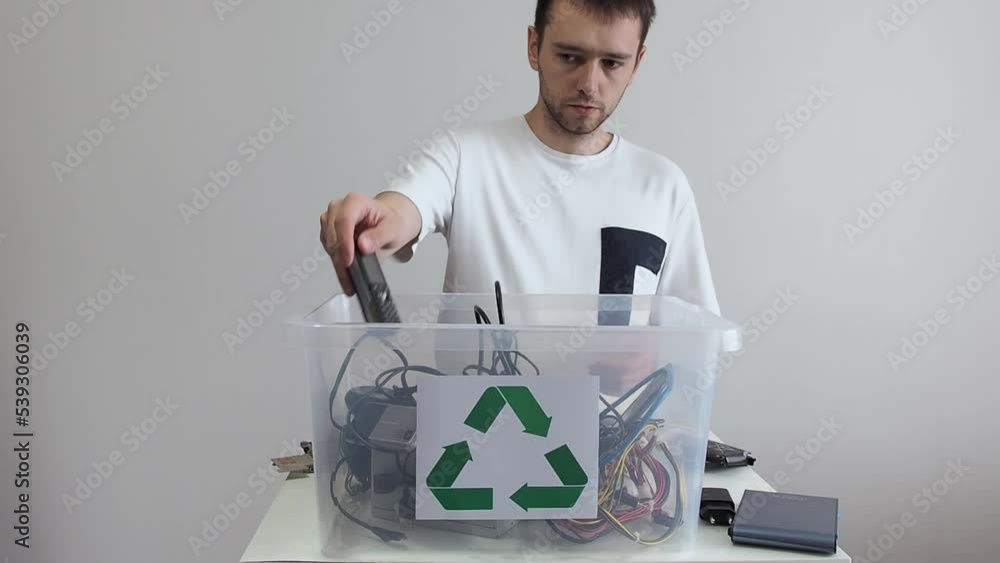 Hazardous and sorting EWaste Recycling. Man throws broken household