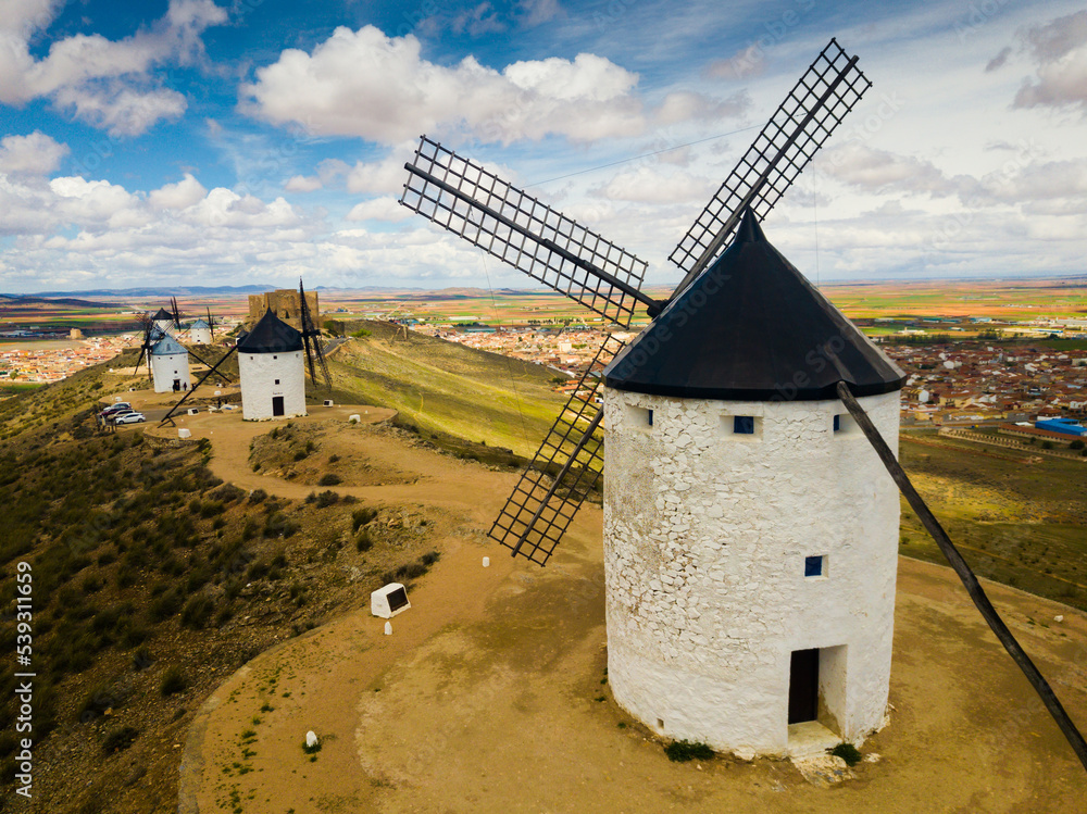Panoramic view of ancient stone wind mills in Consuegra, Spain - obrazy, fototapety, plakaty 