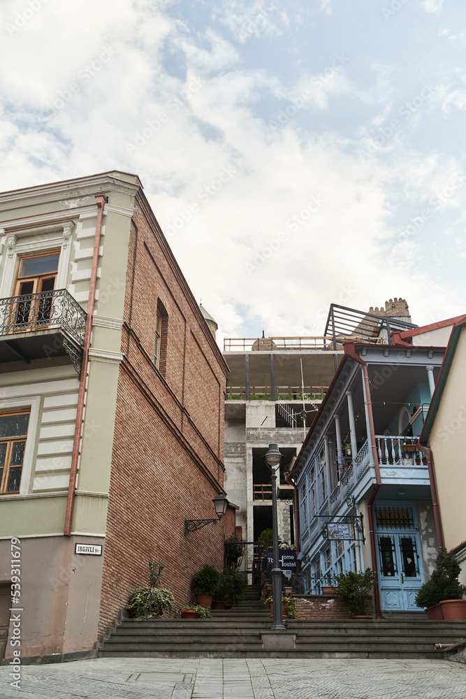 Tbilisi, Georgia - 15.04.2021: A narrow old street in Tbilisi with a staircase between the houses. High quality photo