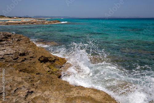 Rocky beach with a turquoise blue sea and waves in spain © Rafael Prendes