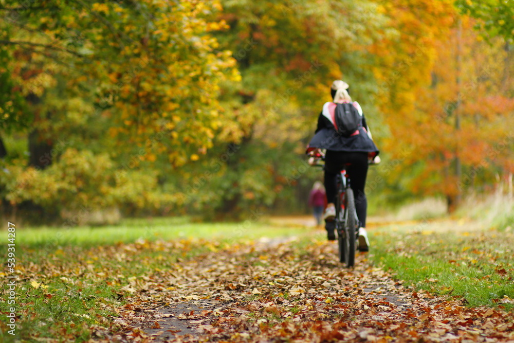 Cycling in the autumn park in europe Cycling in the autumn park in europe