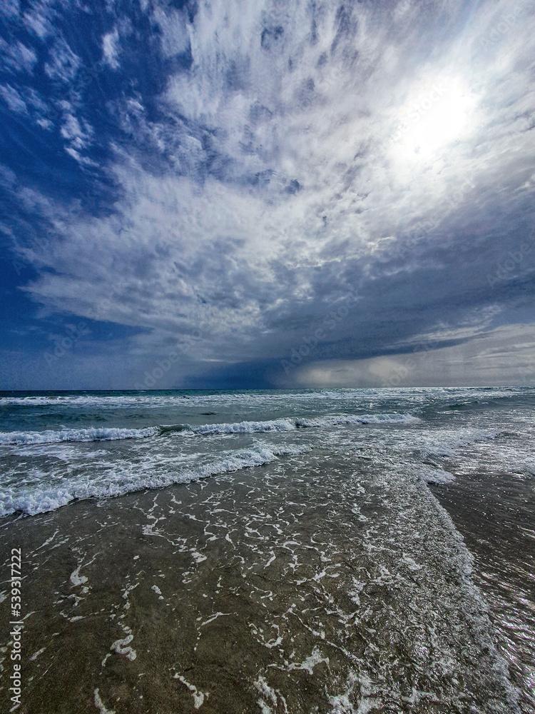  serene seaside landscape with sky with clouds and waves