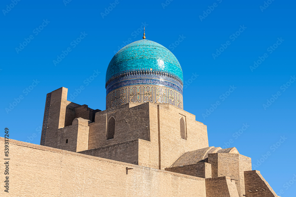 Tower with the ceramic turquoise dome of the Kalyan Mosque in Bukhara