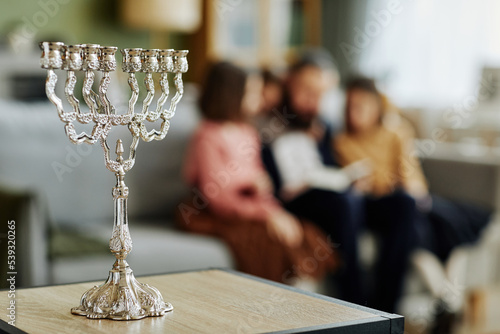 Fotografi Close up of silver Menorah candle on table in jewish family home, copy space