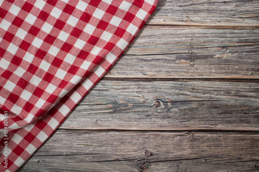 Checkered tablecloth on old wooden table Checkered tablecloth on old wooden table