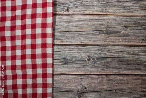 Old wooden table and checkered tablecloth