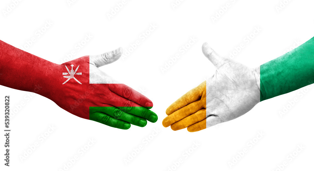 Handshake between Ivory Coast and Oman flags painted on hands, isolated transparent image. Handshake between Ivory Coast and Oman flags painted on hands, isolated transparent image.
