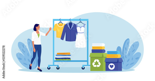 Cloth recycling. Woman packing box with clothes at wardrobe for donation. Recycle and sustainable fashion. Eco-friendly production fabric. People donate dress for benefaction. Charity, social care