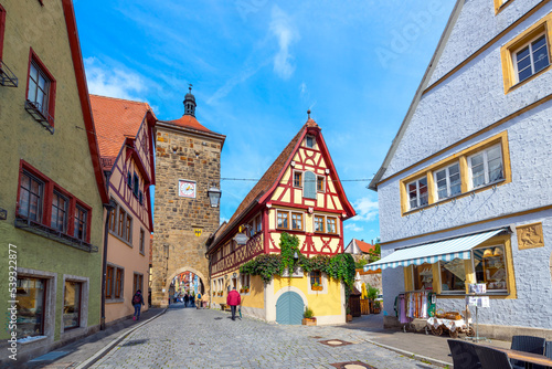 Picturesque half-timbered buildings alongside the Siebersturm city gate in the historic medieval old town of Rothenburg ob der Tauber  Germany.