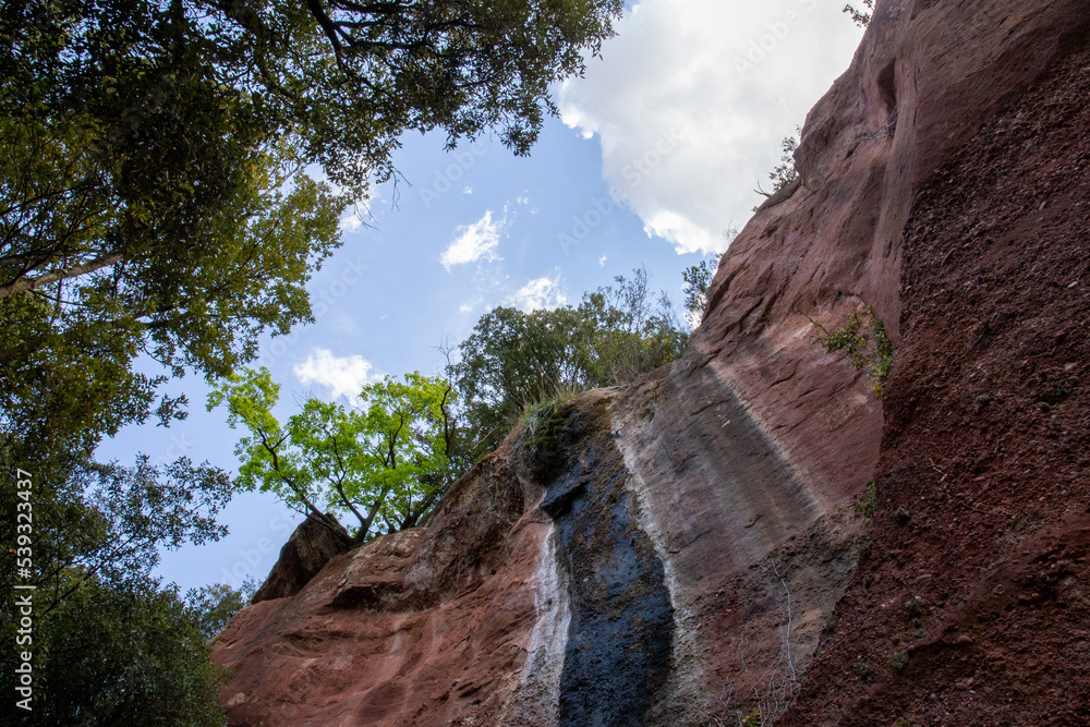 Fototapeta premium Small natural waterfall that marks the wall of the mountain of colors