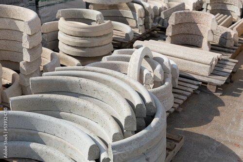 Semicircular rings made of concrete on pallets of a hardware store