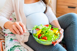 Pregnant salad healthy food. Pregnancy woman eating nutrition diet food salad. Family nutrition, healthy eating concept.