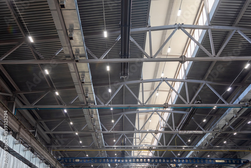 Ceiling with metal beams, air purification and ventilation system, lighting devices in the production shop. Ventilation system in the metalworking shop