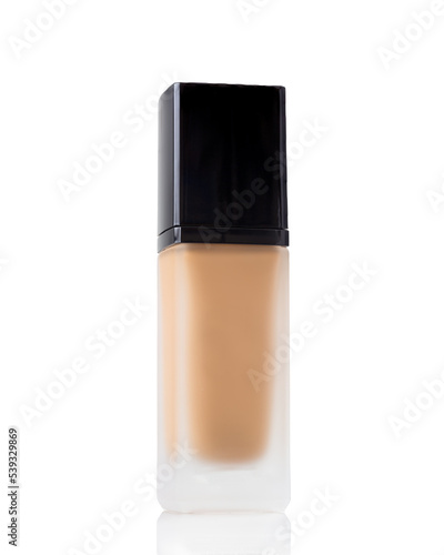 Bottle of a medium shade liquid makeup foundation in a glass bottle on a white background with copy space 