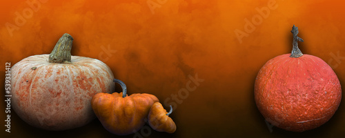 Pumpkins on orange cloudy background