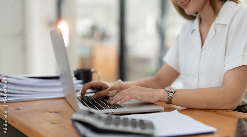 Successful Young Businesswoman Sitting at Her Desk Working on Laptop Computer Successful Young Businesswoman Sitting at Her Desk Working on Laptop Computer