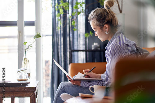 Photography mature asian woman working from home using notebook computer