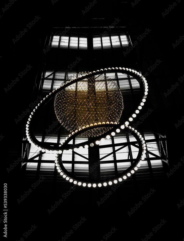 Big circle globe light like earth planet star in space or universe hang on the ceiling with dark background. Textures created from Breathtaking round modern led chandelier, Architecture design decor. Big circle globe light like earth planet star in space or universe hang on the ceiling with dark background. Textures created from Breathtaking round modern led chandelier, Architecture design decor.