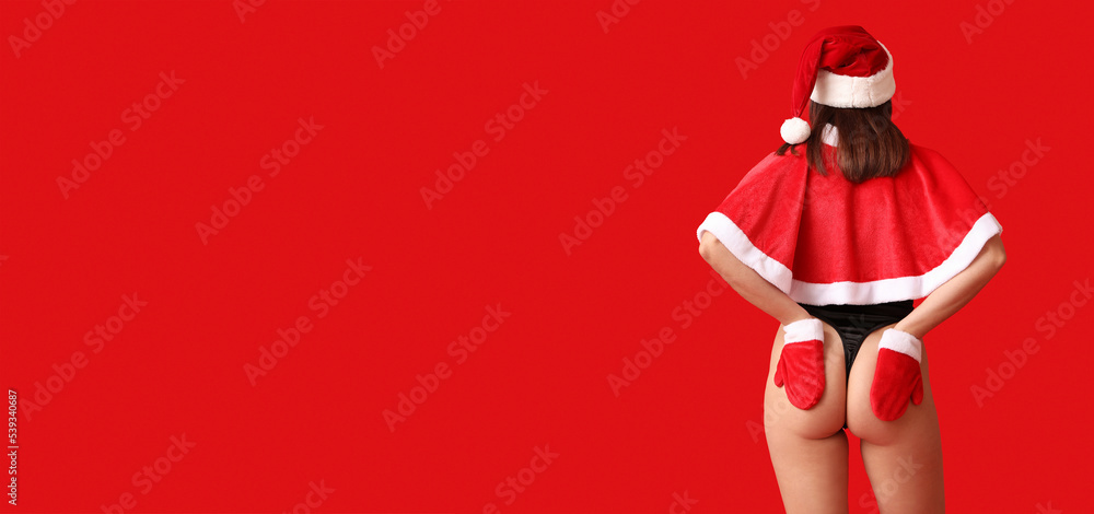 Pretty young woman in sexy Santa costume on red background with space for text - obrazy, fototapety, plakaty 