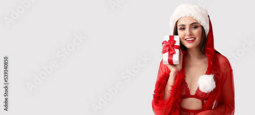Sexy young woman in Santa h...