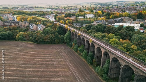 Drone footage of the Penistone Railway Viaduct near Barnsley, South Yorkshire.
Showing a ploughed field, bridge, woodland and railway tracks. photo