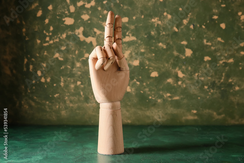 Wooden hand showing letter ...
