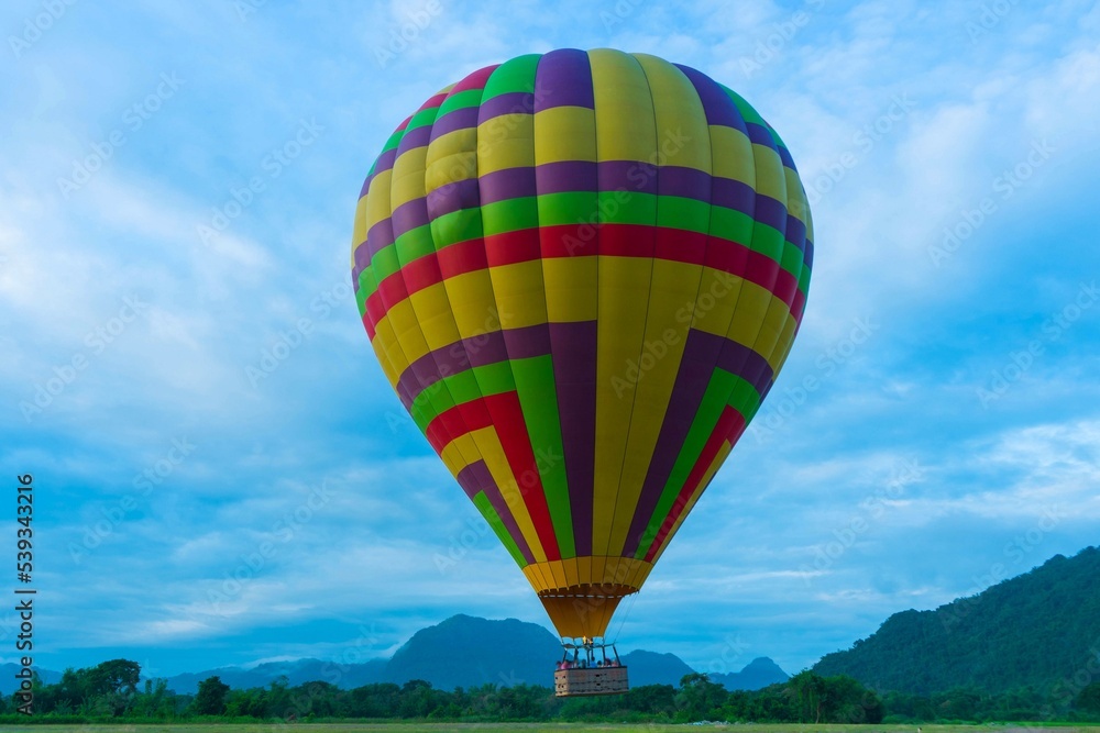 Hot air balloon flying with view mountain landscape blue sky