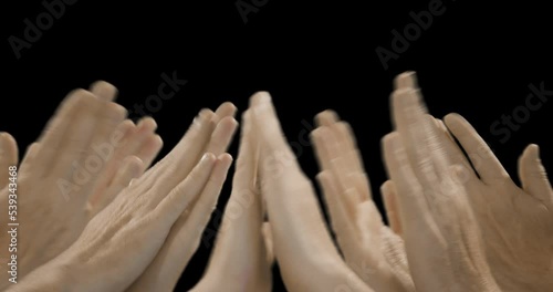 Close-up of a group of hands clapping that fade in one by one. photo