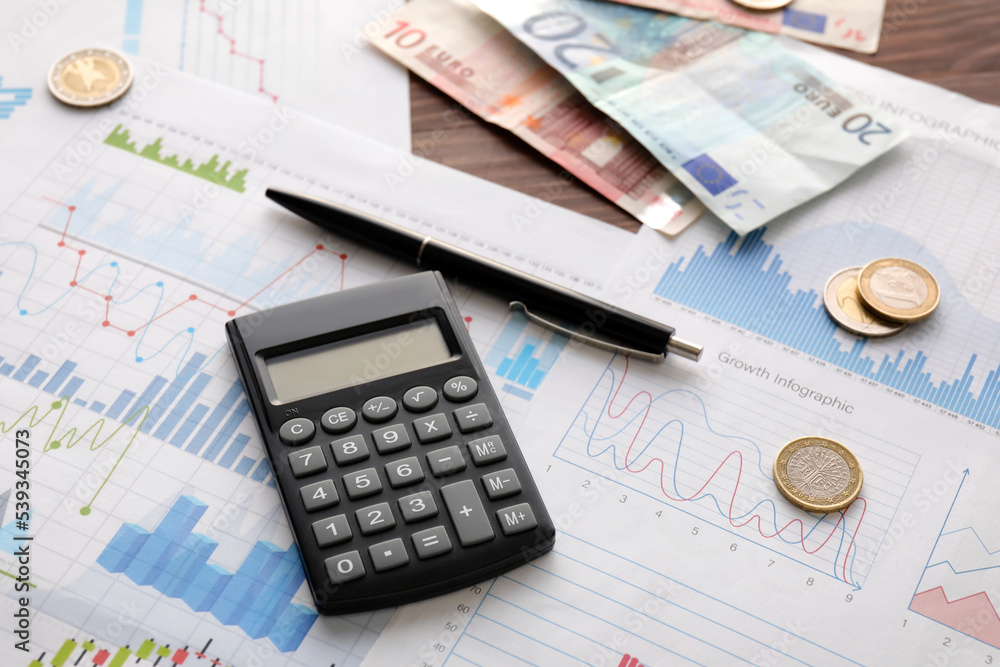 Calculator with money and diagrams on dark wooden background, closeup. Exchange rate concept Calculator with money and diagrams on dark wooden background, closeup. Exchange rate concept