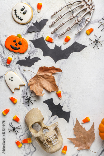 Frame made of Halloween decor with candy corns and cookies on grunge background
