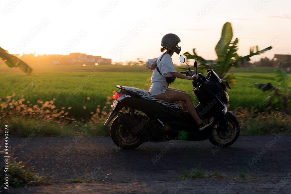 young girl on a motor scooter