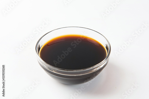 Bowl with traditional vinegar on white background.
