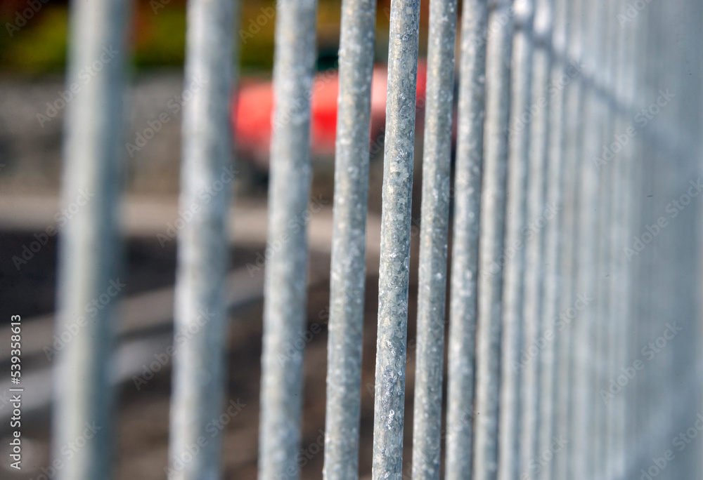 an iron fence made of vertical metal bars an iron fence made of vertical metal bars