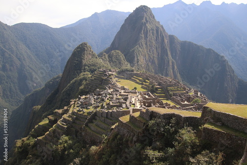 Machu Picchu is a 15th-century Inca citadel located in southern Peru on a 2,430-meter (7,970 ft) mountain ridge. It is located within Urubamba Province above the Sacred Valley, northwest of Cusco. photo
