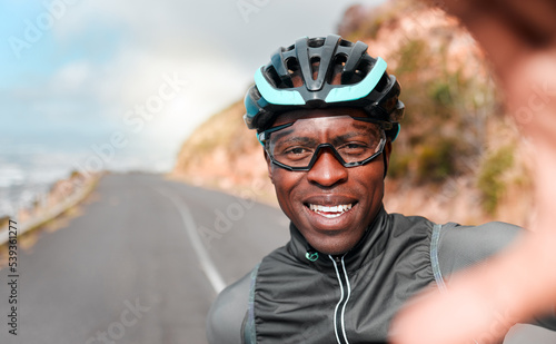 Cycling, portrait and selfie with man in a road along a mountain in South Africa, happy, relax and excited. Fitness, training and face of cyclist photo break during morning cardio exercise in nature
