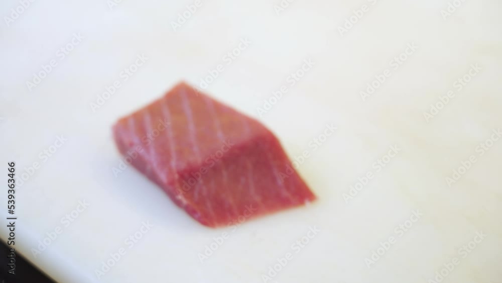 Cutting fresh pieces of tuna for sashimi and nigiri in sushi food restaurants. Cutting fresh pieces of tuna for sashimi and nigiri in sushi food restaurants.