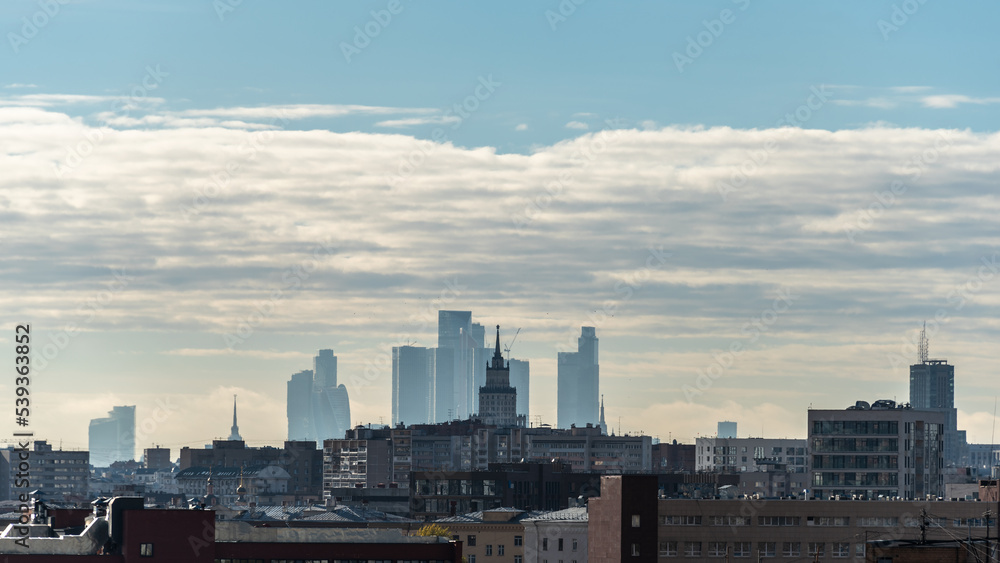 Wide Moscow cityscape with Ukraine hotel and Moscow City Business Center in morning fog.