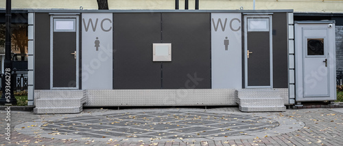 modern outdoor toilet. modern public toilet exterior outdoor. Modern Toilet metal building, outdoor, day time. Facade of outdoor lavatory with men women WC sign