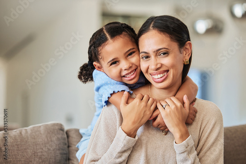 Love, relax and mother and girl on sofa with hug for family, happy and lifestyle together. Smile, support and trust with portrait of mom and child in living room at home for care, youth and happiness