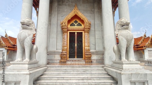 White Singha in front of gate of ordination hall in Wat Benchamabophit Dusitwanaram, Bangkok, THAILAND.