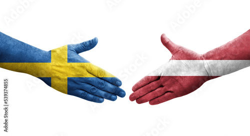 Handshake between Latvia and Sweden flags painted on hands, isolated transparent image.