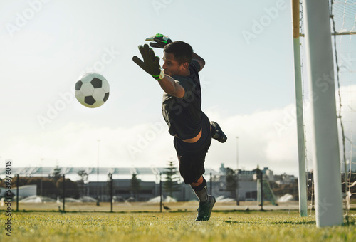 Bilde på lerret Soccer, goalkeeper and jump, saving ball from goals at outdoor sports field